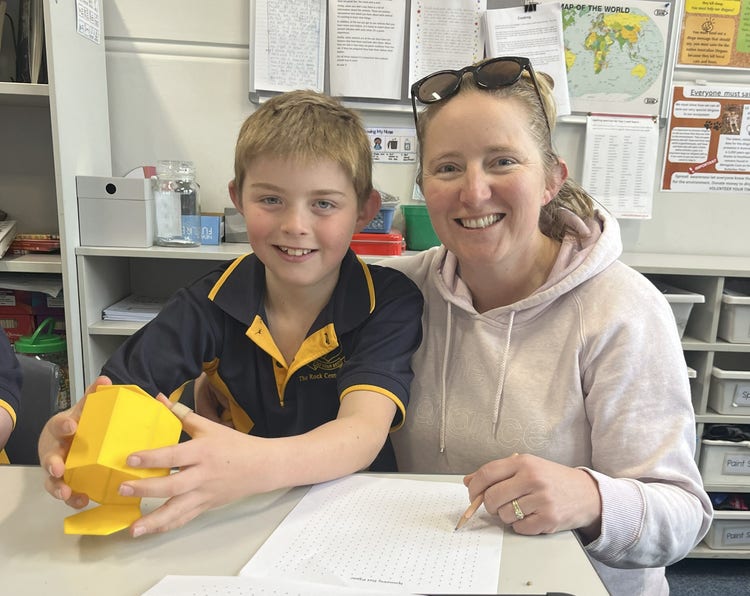 Student and parent sitting at a desk - open day for Education Week 2025