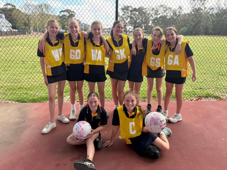 A girls' netball team posing for a photograph