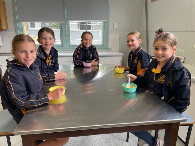 Breakfast Club, group of girls sitting at a table eating cereal